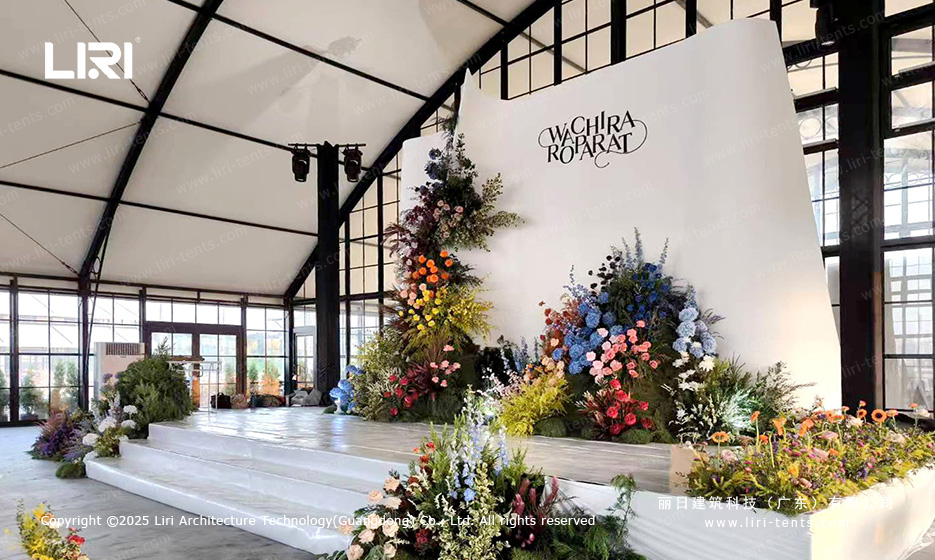 Modular wedding tent ceremony stage and floral backdrop