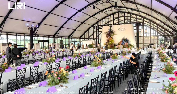 Long-table reception inside a modular wedding tent