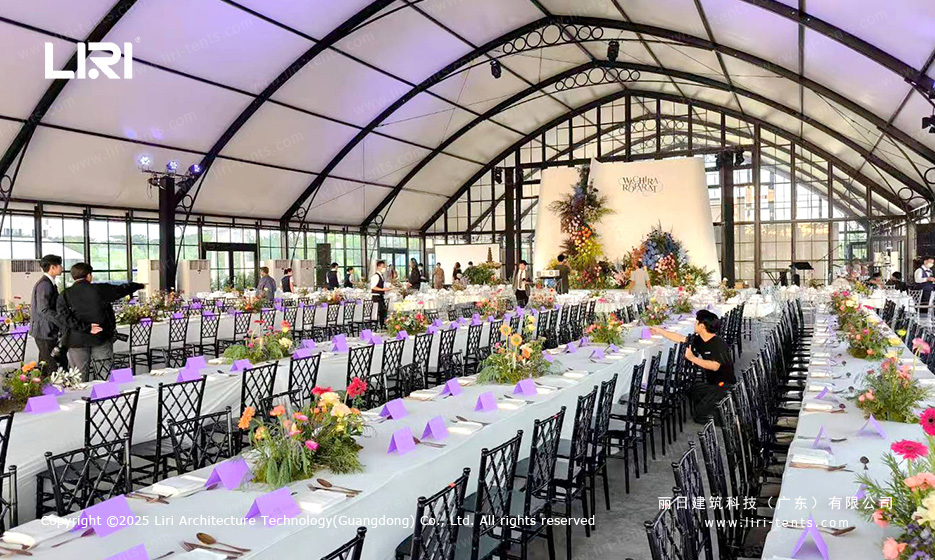 Long-table reception inside a modular wedding tent