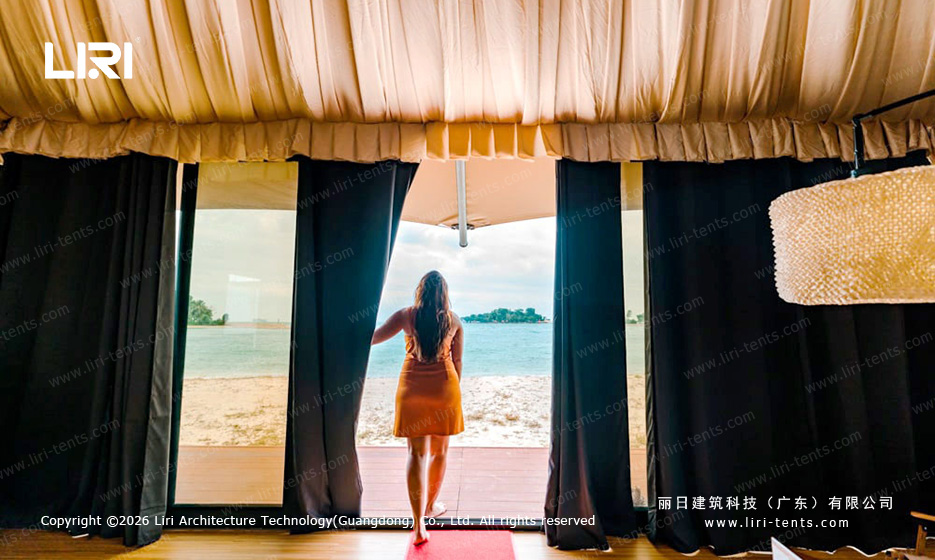 Indian-style tent interior lounge reception area — multi-peak event tent with tensioned fabric roof, resort common space