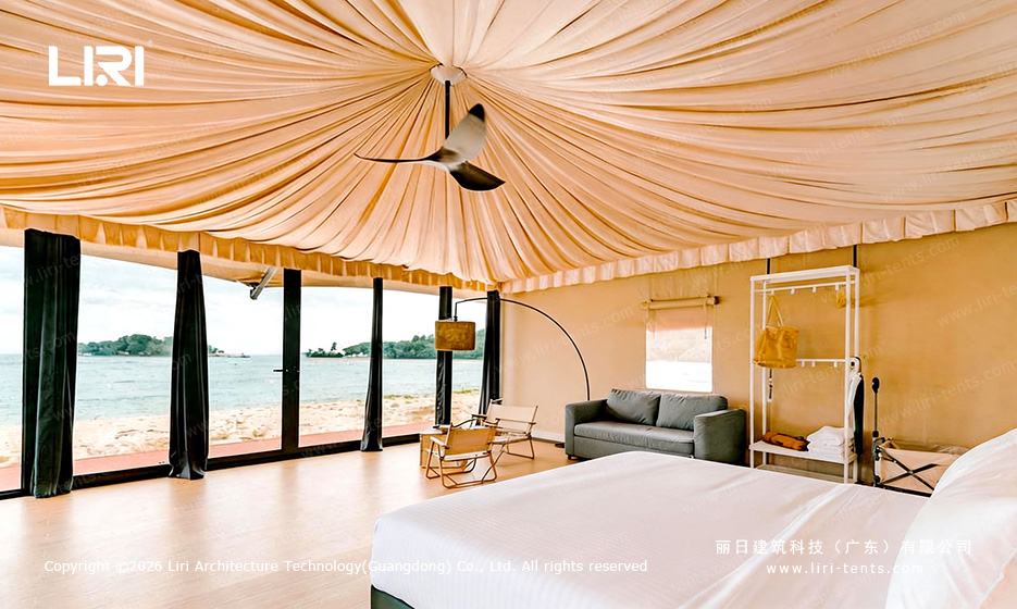 Night view Indian-style glamping tent lit from inside — LED lighting through tensioned fabric canopy, resort atmosphere