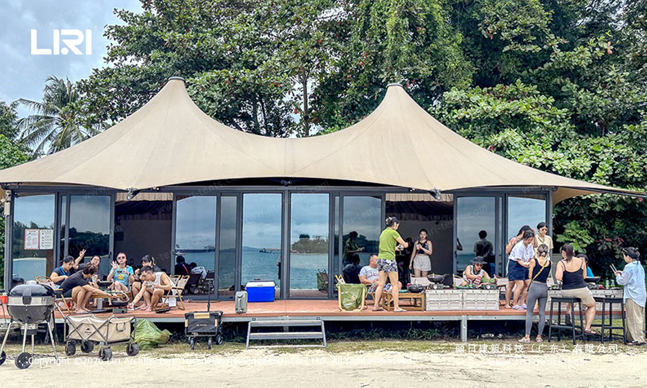 Panoramic ocean view from glamping tent bed — clear sidewall Indian-style tent, luxury resort accommodation on beach