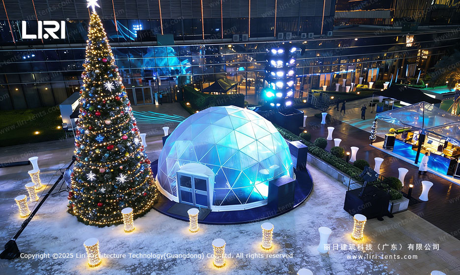 Aerial view of a transparent dome tent in a festive outdoor plaza