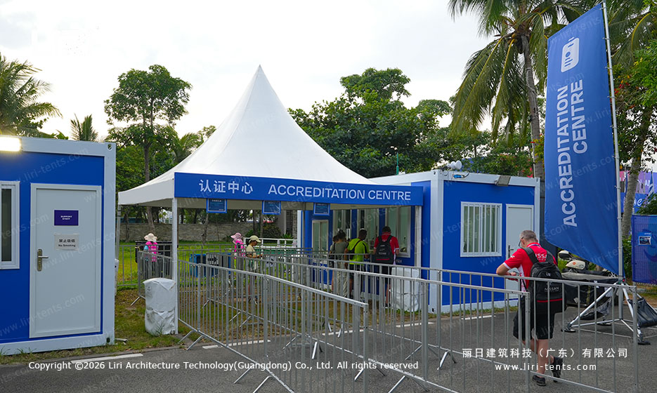 Pagoda tent at accreditation centre with security barriers