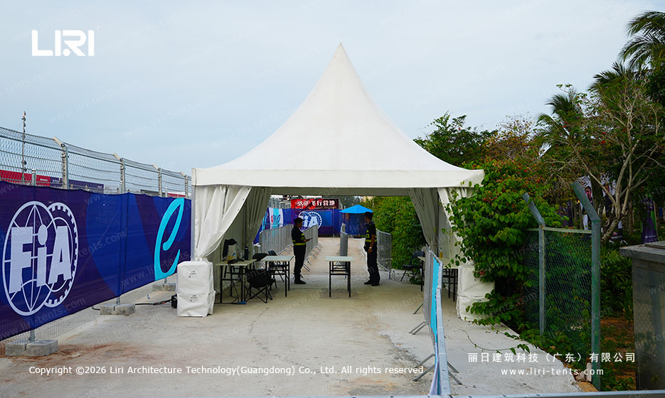 Reception area inside transparent marquee with high tables
