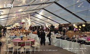 Guests gathered at banquet reception inside clear-span tent with transparent roof