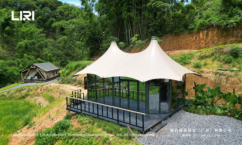 Glass-wall side view of twin-peak tipi tent with wooden deck platform
