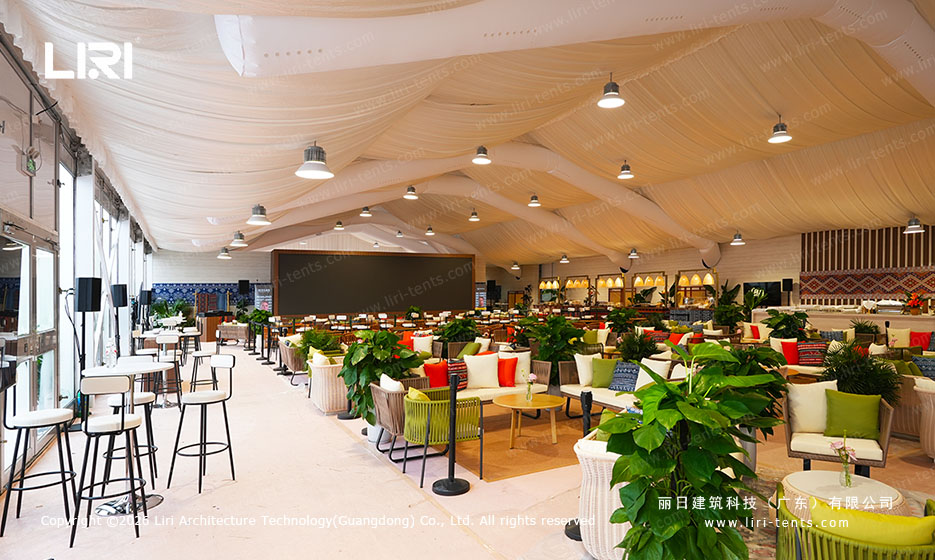 Draped luxury lounge inside marquee with patterned cushions