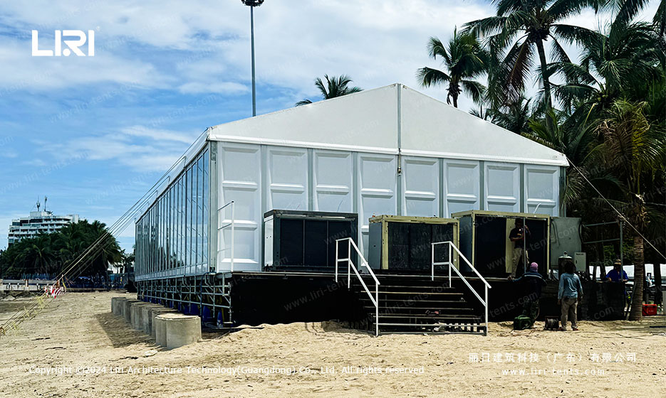 white aluminum VIP tent exterior with clear side openings and track-side view