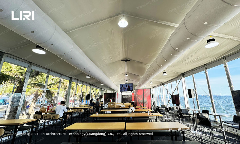 lounge furniture arrangement inside VIP marquee tent with bar counter and lighting