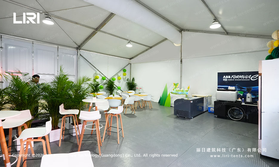 VIP reception area with high cocktail tables and tropical plants